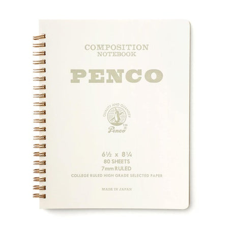 White notebook with gray text saying, “Composition Notebook PENCO”. Gold coil binding on left side of notebook.