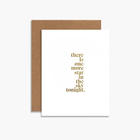 White card with gold foil text saying, “There is one more star in the sky tonight”. A brown kraft envelope is included.