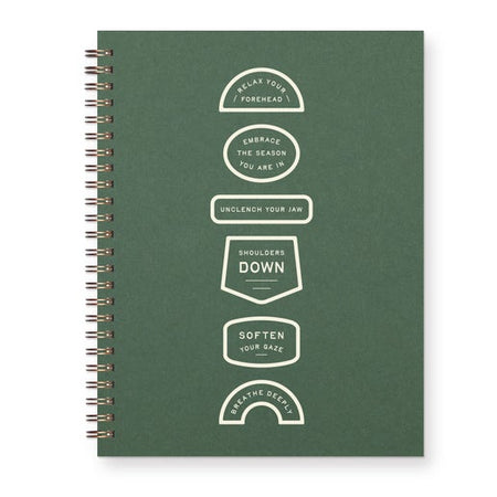 Green notebook with white text and design on a white background. Shapes forming a vertical flowchart with text saying, “Relax your forehead. Embrace the season you are in . Unclench your jaw. Shoulders down. Soften your gaze. Breathe deeply.” Gold coil binding on left side.