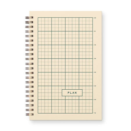 Notebook with grid layout and 'PLAN' label on beige cover. Gold coil binding on left side.