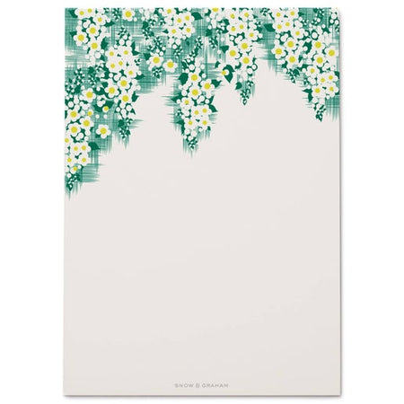 White notepad with images of hanging greenery with yellow and white flowers across the top border.