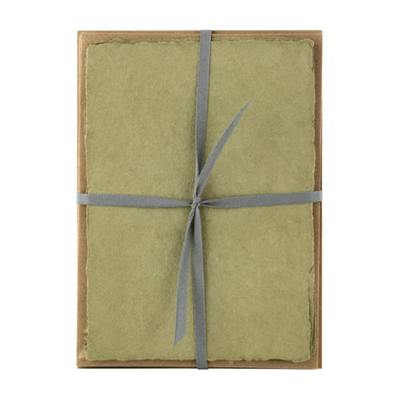 Olive green paper with torn edge wrapped and tied with a gay ribbon.
