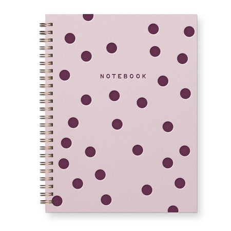 Pink notebook with purple polka dots with purple text saying, “NOTEBOOK” in the  top center. Gold coil  binding on left side.