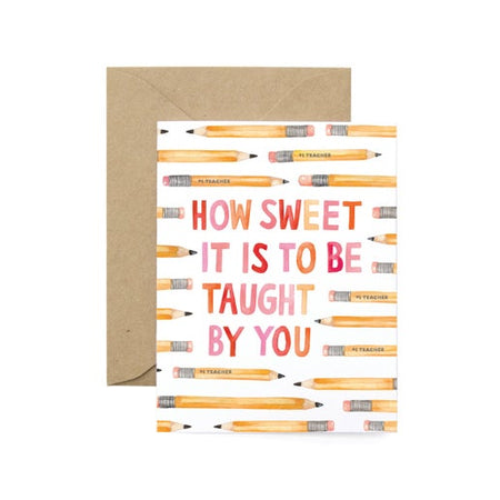 White card with images of several number 2 pencils across card. Red and pink text saying, “How Sweet it is to be Taught By You”. A brown kraft envelope is included.