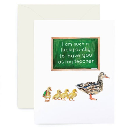White card with image of a green chalkboard with white text saying, “I am such a lucky ducky to have you as my teacher”. Images of a large duck with four yellow ducklings following behind. A white envelope is included.