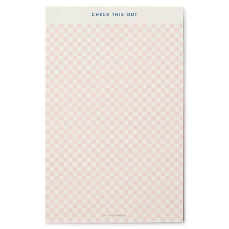 Notepad with pink and white checkered pattern and white border across the top. Blue text in top center saying, “Check This Out”.