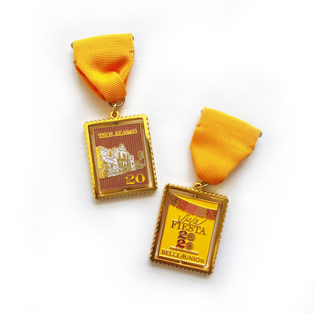 Square gold medal with images of the Alamo on one side and gold text saying, “Viva Fiesta 2020” on the other side. Gold ribbon attached to the top.
