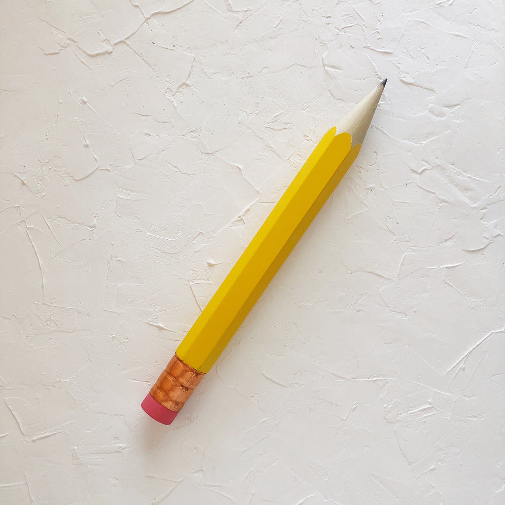 Pencil with yellow body and copper top eraser.