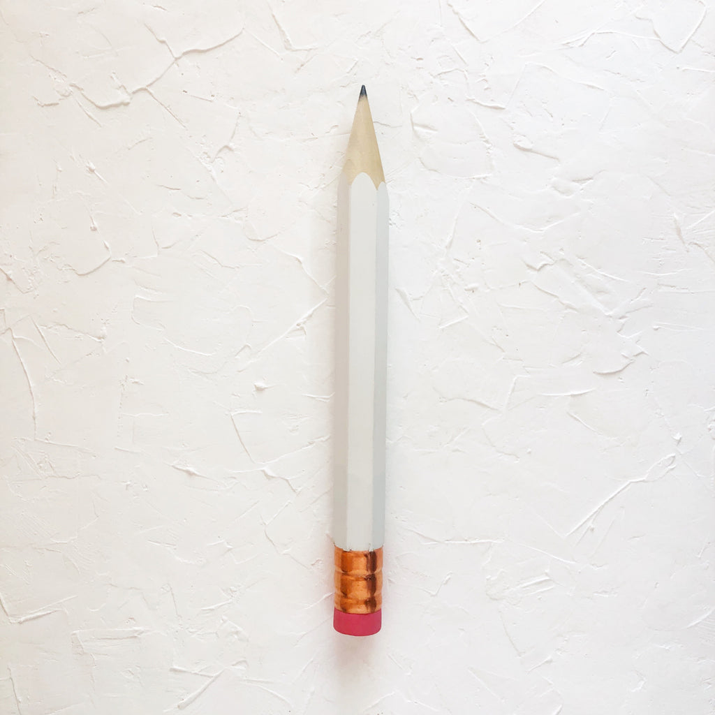 Pencil with white body and copper top eraser.