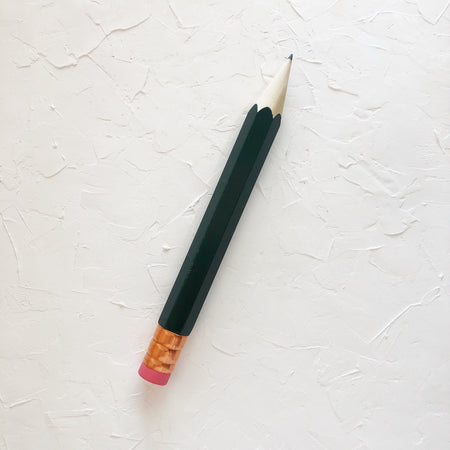 Pencil with green body and copper top eraser.