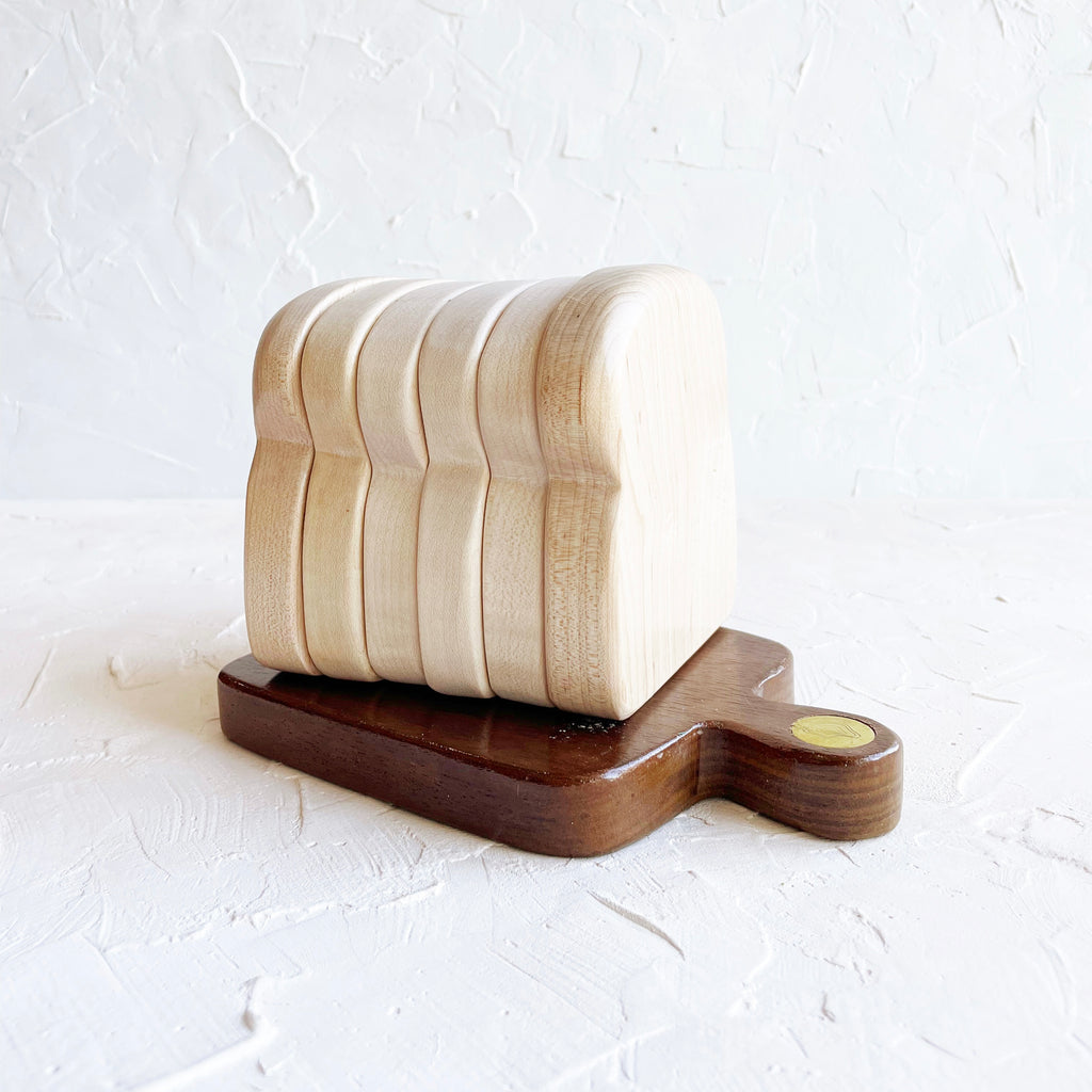 Wood coasters in the shape of a sliced loaf of sandwich  bread.