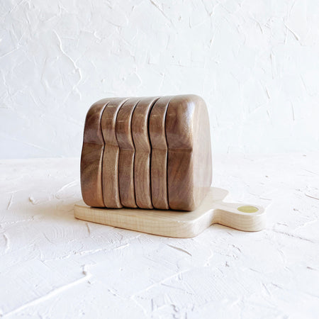 Wood coasters in the shape of a sliced loaf of sandwich  bread.