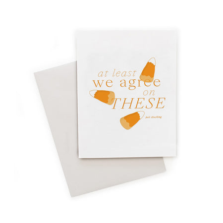 White card with orange text saying, “At Least We Agree on These Just Checking”. Images of yellow, orange and white candy corn. A gray envelope is included.