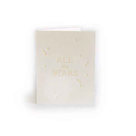 Ivory card with gold text saying, “All the Stars”. Images of small embossed stars scattered across card. An envelope is included. 
