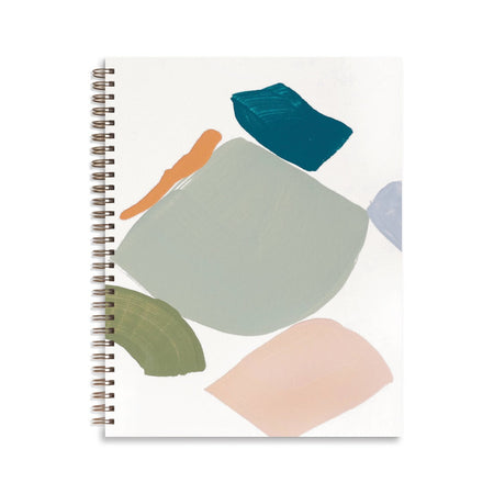 White cover with abstract shapes in the colors of blue, gray, orange, tan, olive green. Gold metal coil binding on left side.