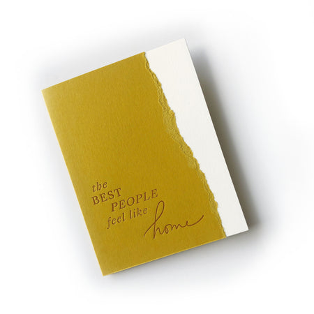 Gold card with torn right edge and brown text saying, “The Best People Feel Like Home”. An envelope is included.