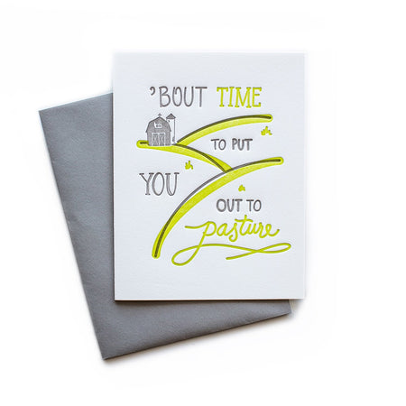 White card with gray and yellow text saying, “Bout Time To Put You Out to Pasture”. Images of hills, a farm barn and a silo. A gray envelope is included.