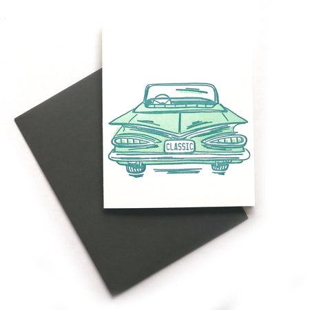 White card with images of a vintage classic green convertible car with “CLASSIC” printed in green text on the back license plate. A black envelope is included.