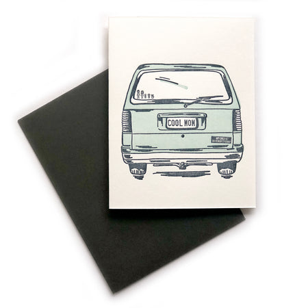 Ivory card with image of a vintage green station wagon with “COOL MOM” in black text on back license plate. A black envelope is included.