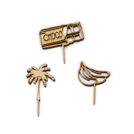 Wooden pie picks in the cutout shapes of banana, chocolate bar and palm tree.