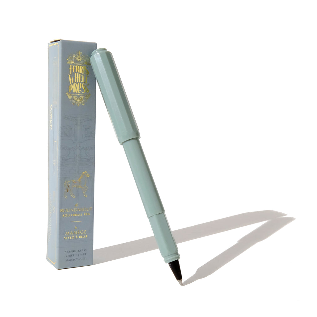 Mint green pen with black and silver tip. Mint green cap. Packaged in mint green box with gold text saying, “Ferris Wheel Press” with image of a carousel horse.