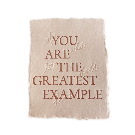Tan card with torn edges and brown and embossed text saying, “You Are the Greatest Example Of What Love Should Be”. A gray envelope is included.