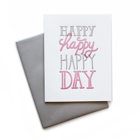 White card with gray and pink text saying, “Happy Happy Happy Day”. A gray envelope is included.