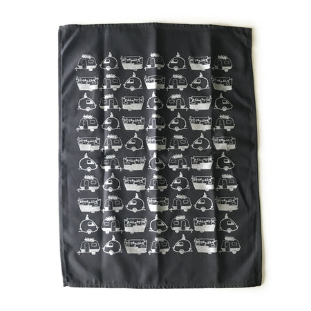 Black tea towel with images of white vintage campers tiled across towel.