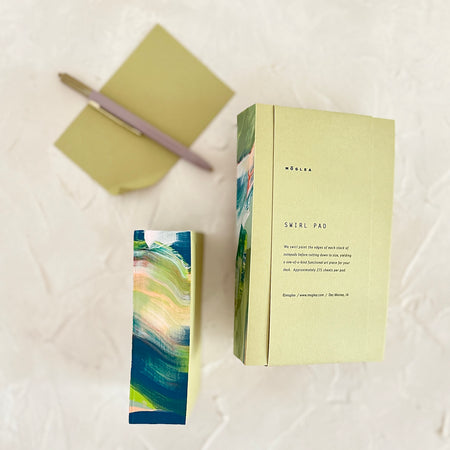 Square note pad with varied colored swirl banding in colors of blue, green, white, teal and tan.