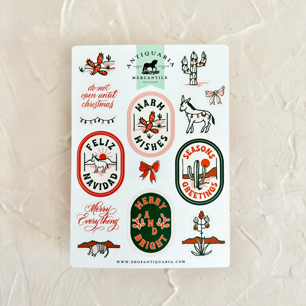 Stickers with various images of desert scenes and cactus plants with text of holiday greetings.