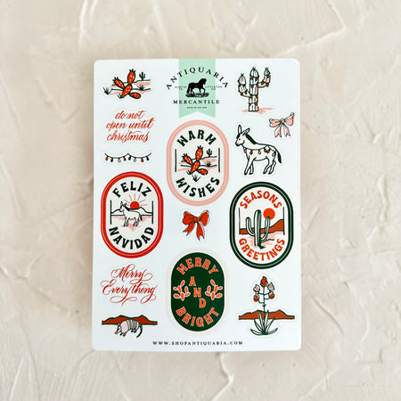Stickers with various images of desert scenes and cactus plants with text of holiday greetings.