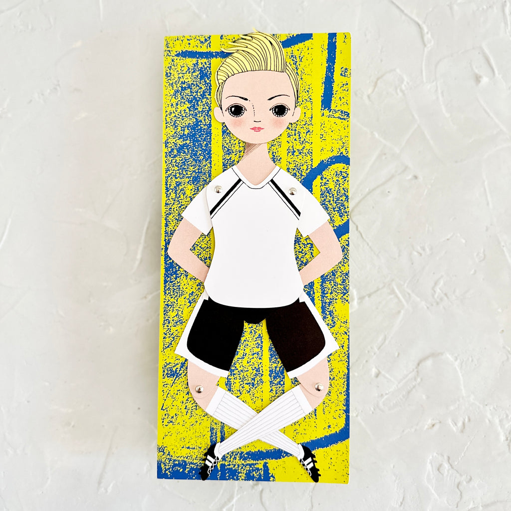 Card with yellow and blue textured background with image of a girl soccer player. 