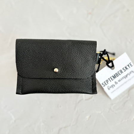 Black leather wallet pouch with gold button in center.