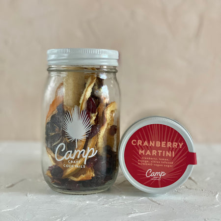 Cocktail jar with dried cranberry, lemon and orange.