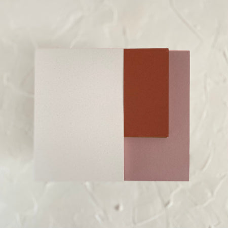 Rectangle note pads with white, burgundy, and mauve colored covers.