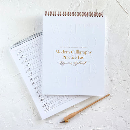 White cover with embossed alphabet letters and brown text saying, 