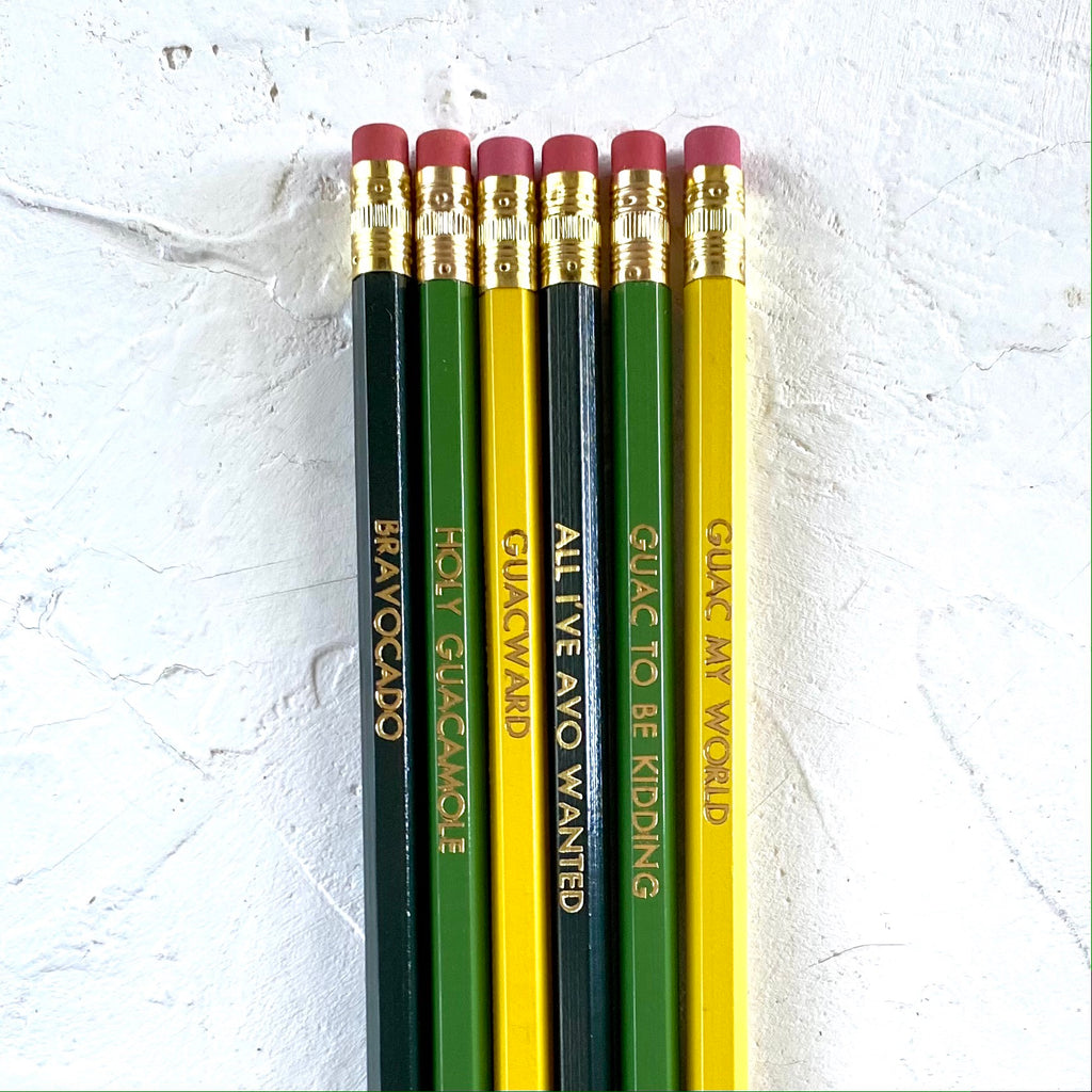 Pencil set with green, yellow and blue pencils. Gold text on each pencil saying, “Bravocado”; “Holy Guacamole”; Guacward”; “All I’ve Avo Wanted”; Guac to be Kidding”; and “Guac My World”. 