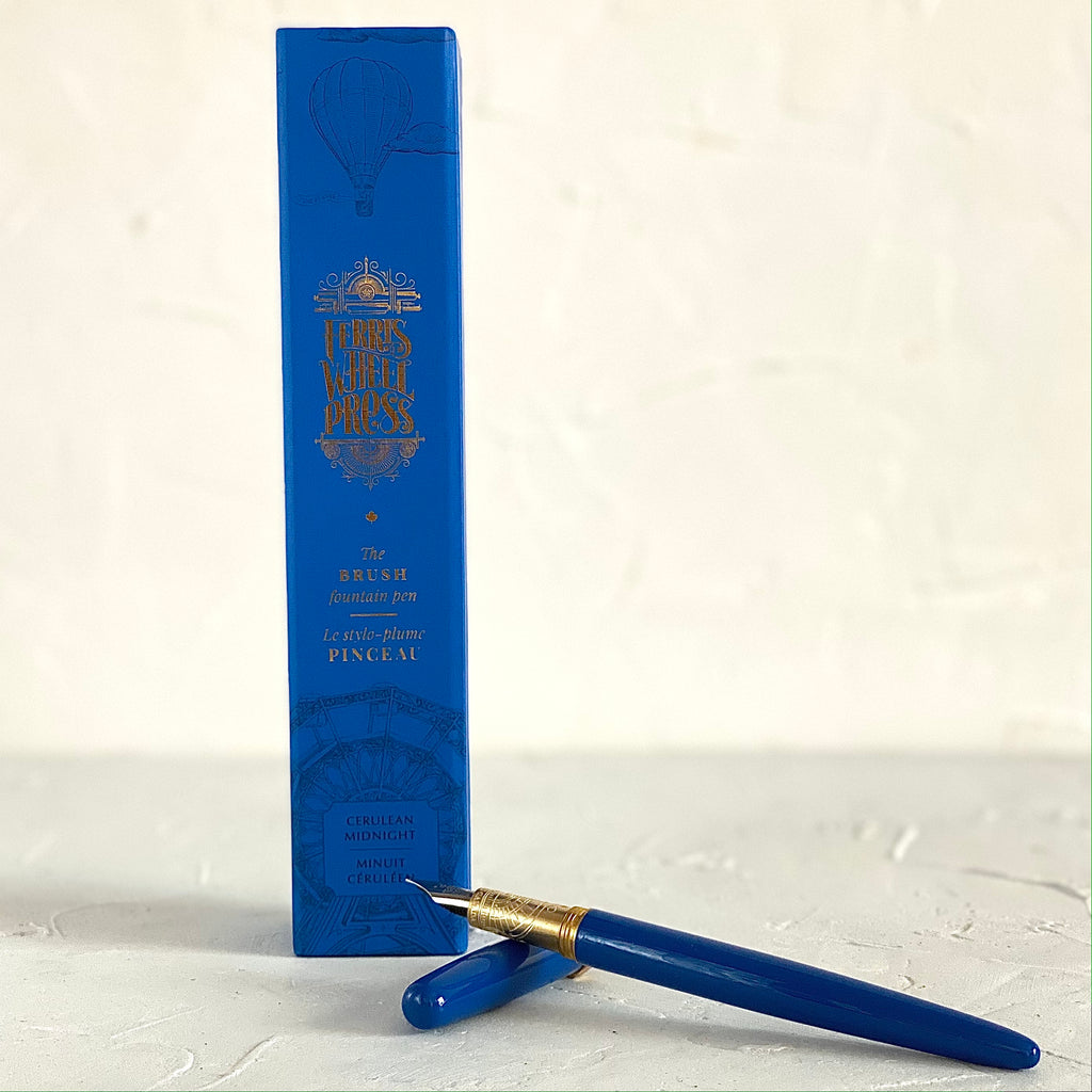 Blue pen with gold banding and silver nib tip. Blue cap. Packaged in blue rectangular box with gold text saying 