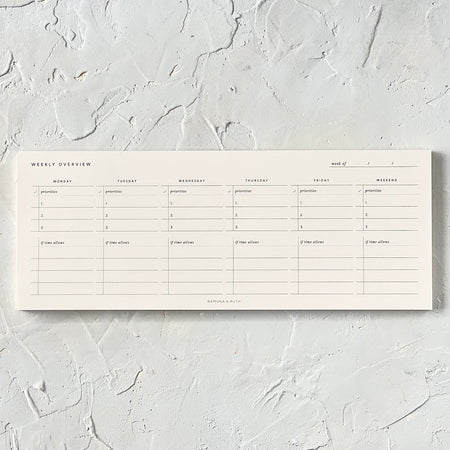 Rectangle ivory color pad with weekly grid to fill in.