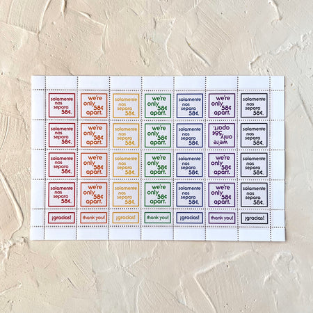 Sheet of stickers in different rainbow colored text saying, 