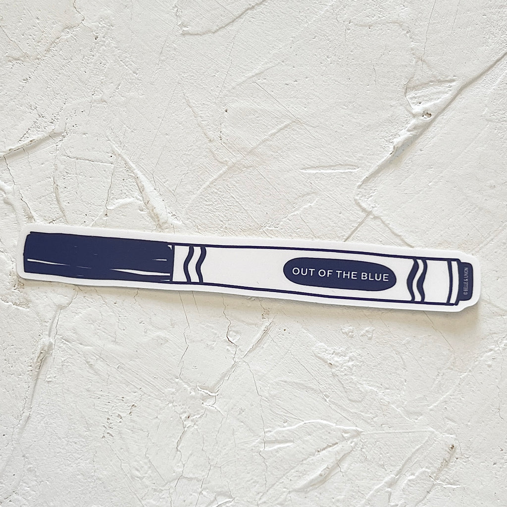 White sticker in the image of a blue classic child’s marker with white text saying, “Out of the Blue”.