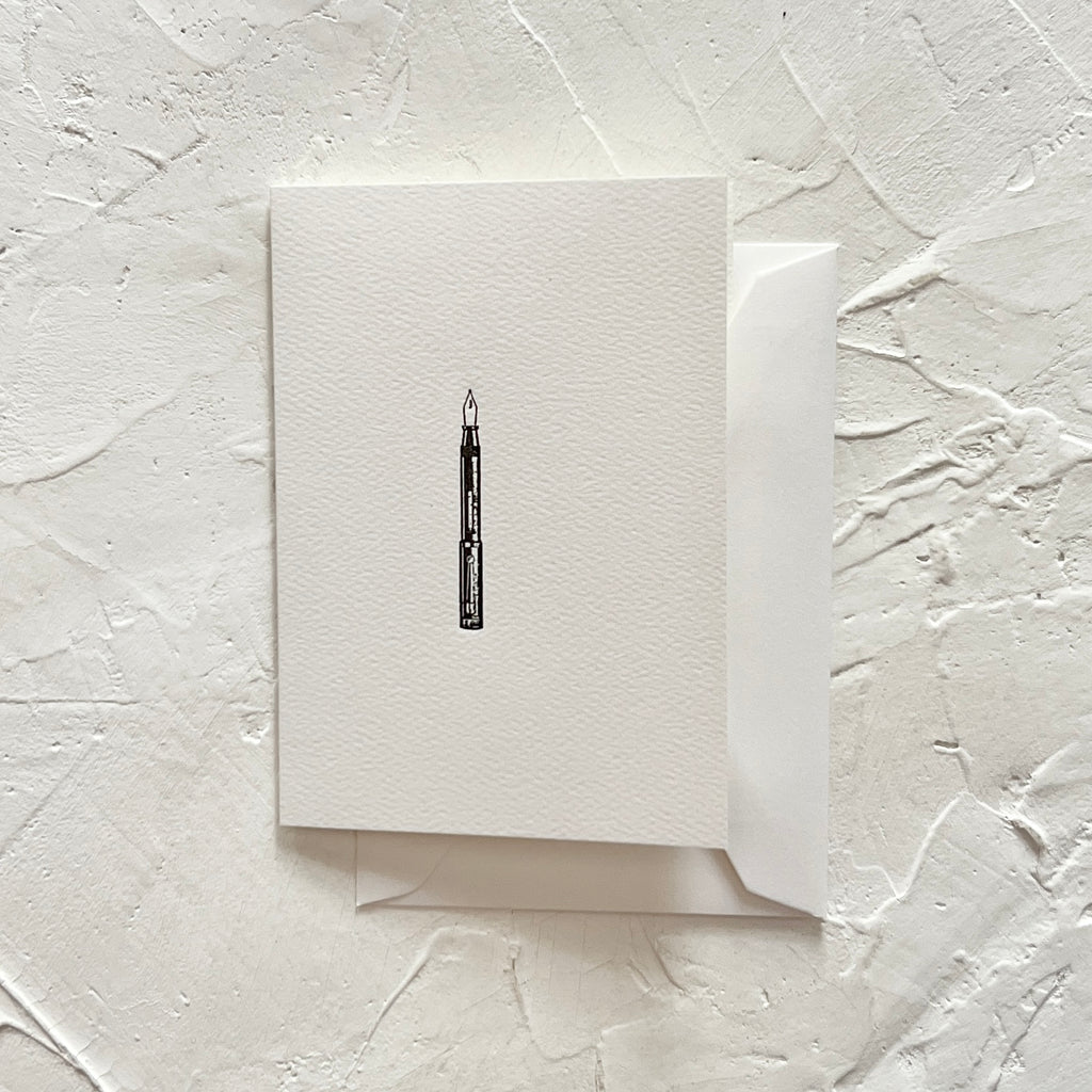 White card with an image of a black fountain pen. A white envelope is included.