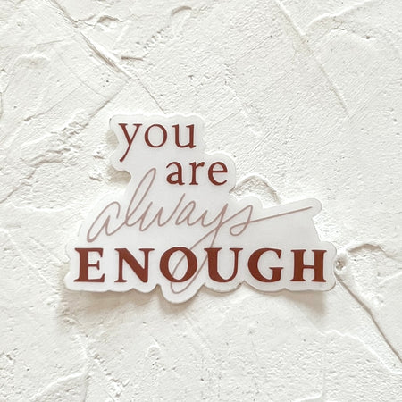 White sticker with brown text saying, “You Are Always Enough”. 