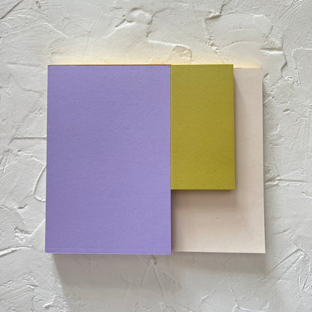 Rectangle notepad with purple, olive green and tan covers.