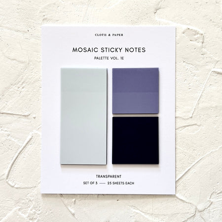 Square and rectangele sticky notes in gray, blue and black shades presented on a ivory background.