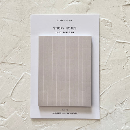 Gray sticky notes with vertical white lines.