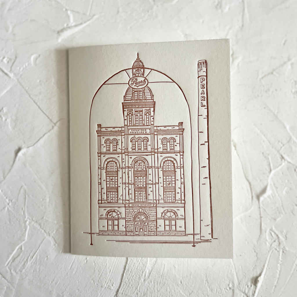 Ivory card with red ink. Image of a building from the Pearl District in San Antonio. A gray envelope is included.
