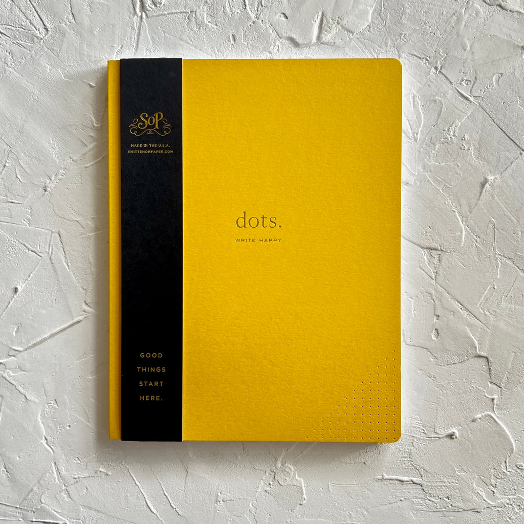 Yellow cover with gold foil text saying, “Dots”.