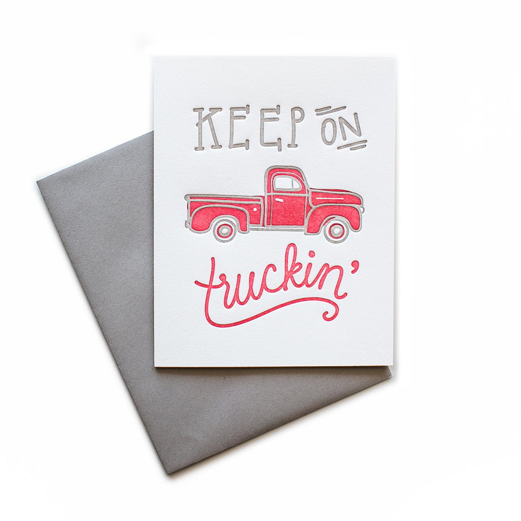 White card with gray and red text saying, “Keep on Truckin’”. Image of a red pickup truck. A gray envelope is included.