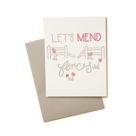 White card with gray and red text saying, “Let’s Mend Fences”. Images of a broken fence with grass and red flowers. A gray envelope is included.